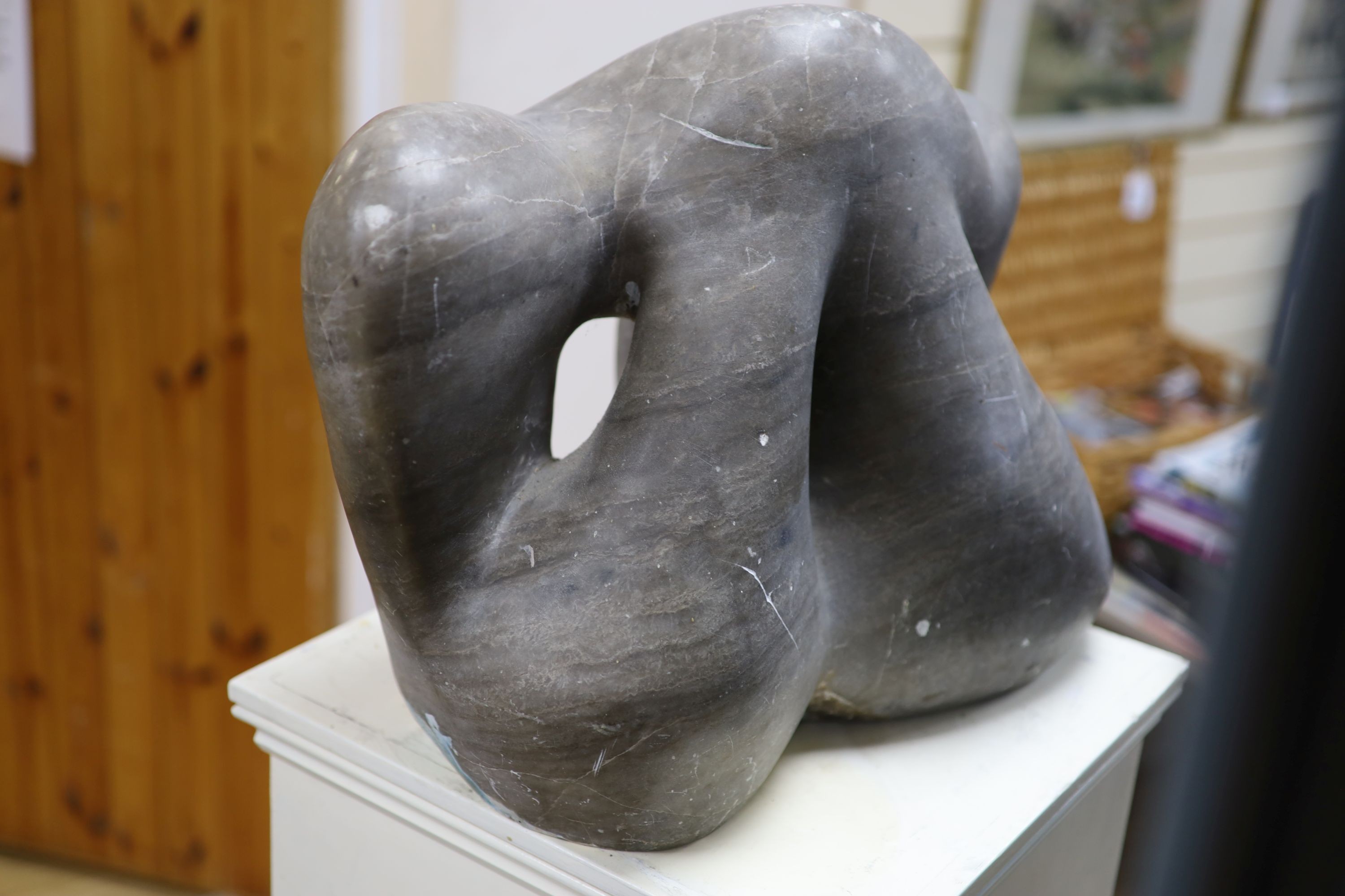 Wilby Hart, grey marble sculpture, abstract form, W 46cm. H 35cm. on a painted wood pedestal.